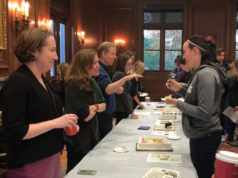 History professors speak with students about their upcoming Winter Quarter classes, serving cake