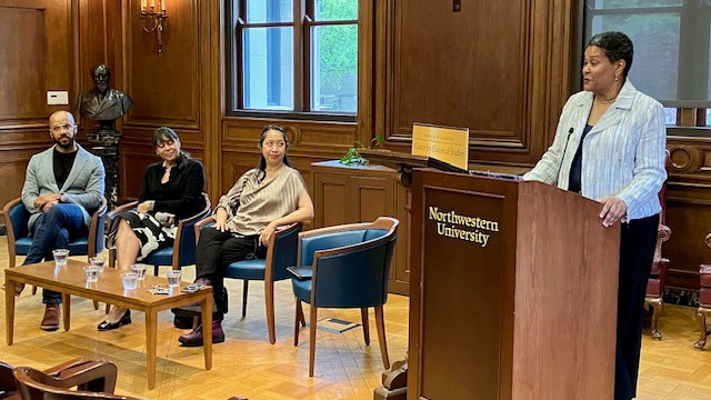 Leslie Harris at podium with panelists