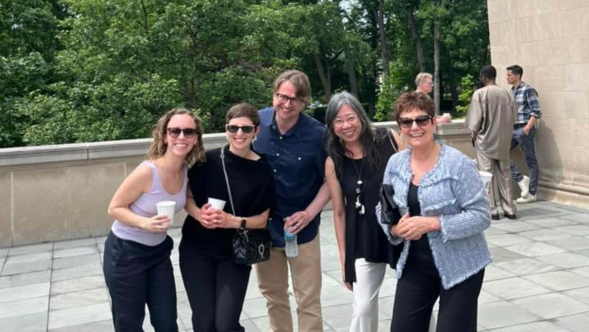 Sarah Maza smiles with faculty