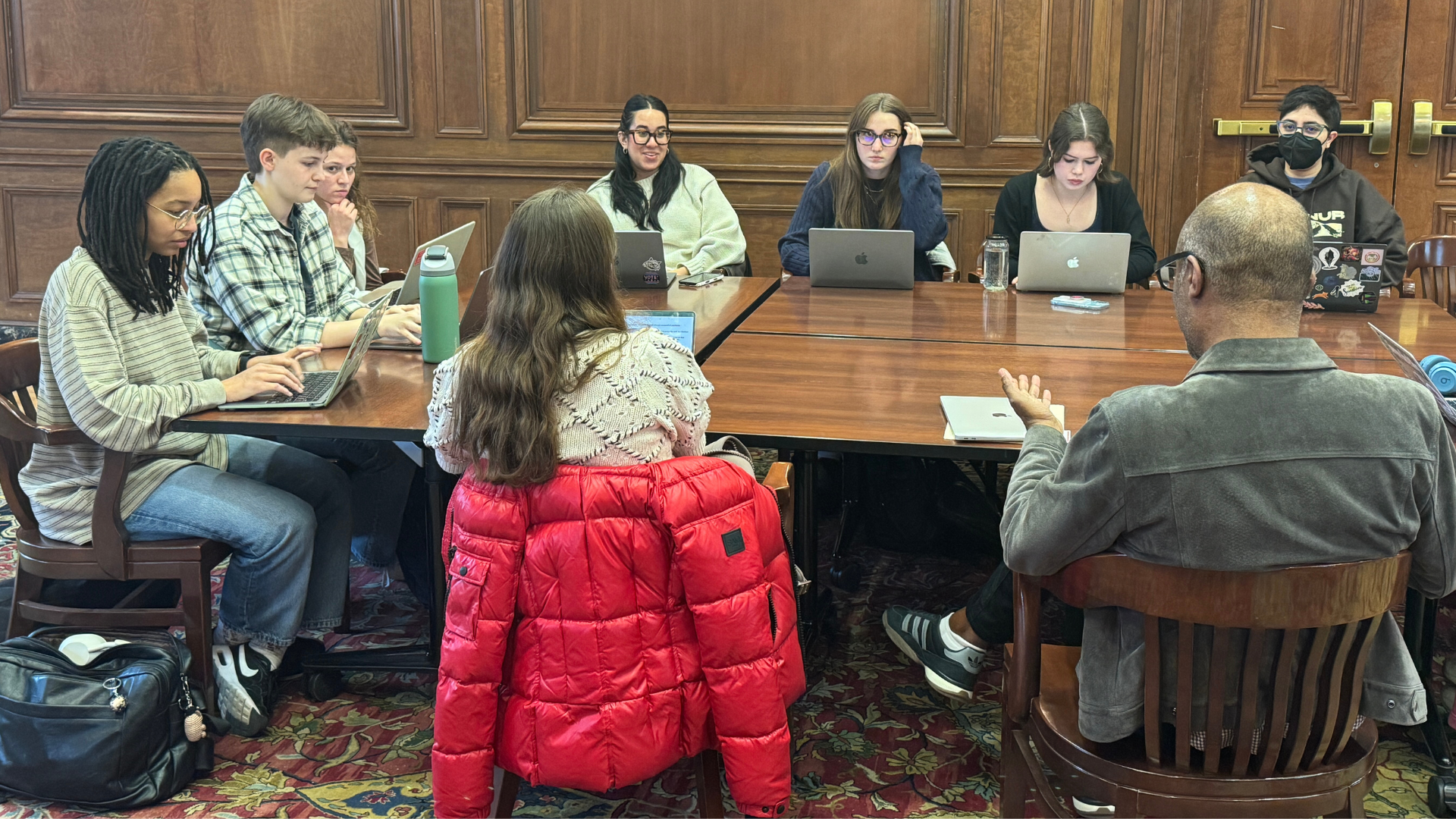 Prof. Gadsden with students around the table