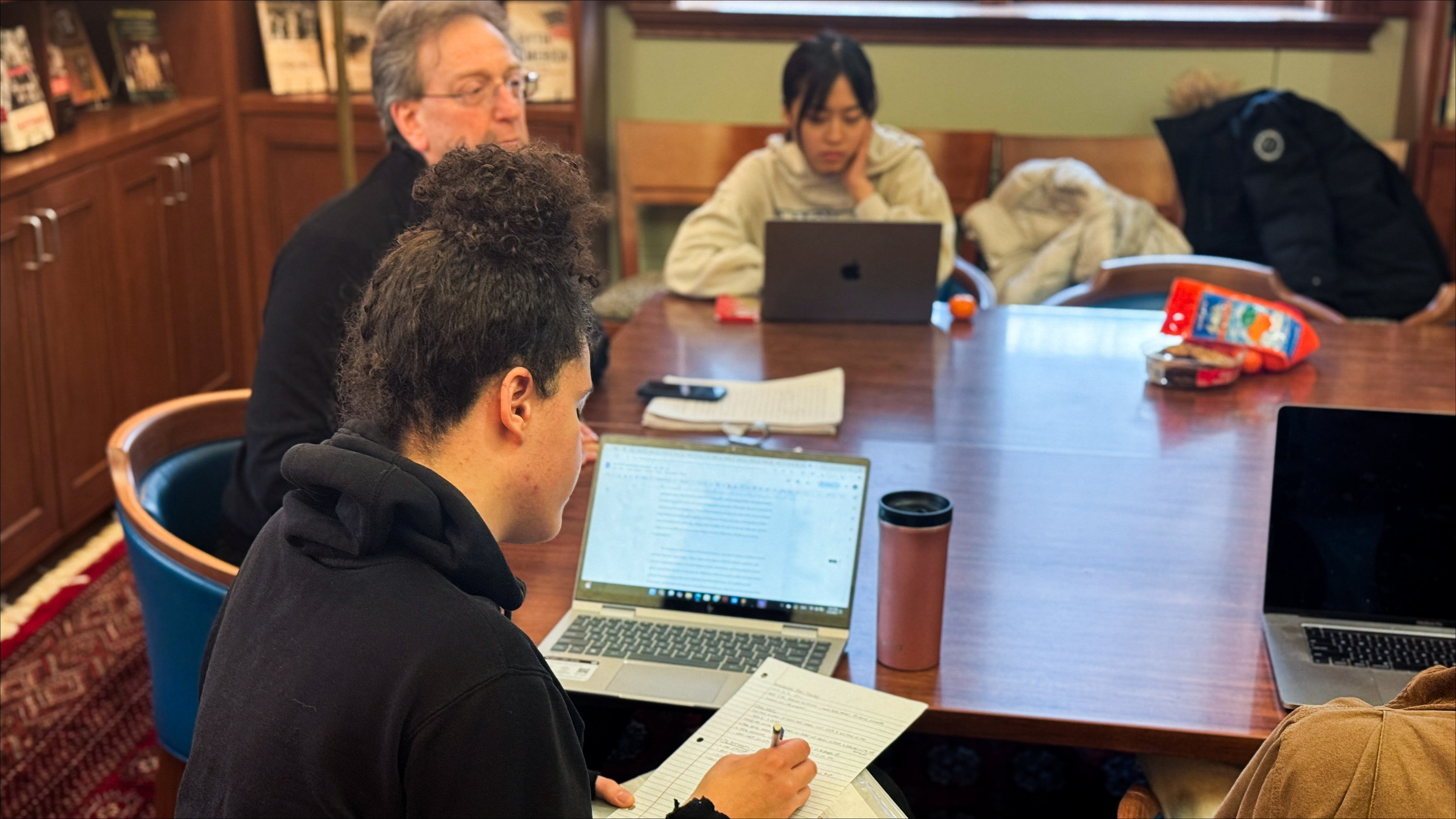 Thesis writers in discussion in the History Seminar Room, a classic and warm-lite room